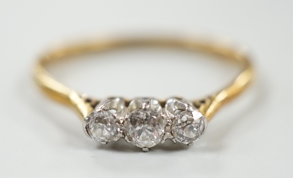 An 18ct & plat, three stone diamond ring, size P/Q, gross weight 2.2 grams.